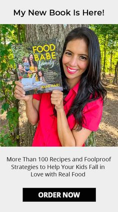 a woman holding up a book in front of her face with the caption,'my new book is here more than 100 recipes and foolroof strates to help your kids fall in love with real food