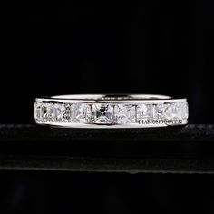 a white gold ring with princess cut diamonds