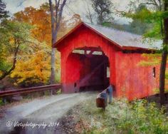 a painting of a red covered bridge in the fall with trees and foliage around it