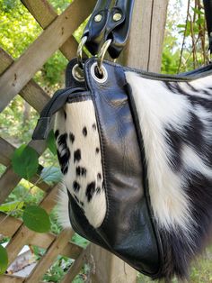 Elevate your accessory game with our stunning spotted black and white cowhide shoulder bag. Whether it's a day at the beach, poolside relaxation, or classy events, this bag is your perfect companion. These cowhide shoulder bags are free shipping worldwide. Size: 12(L) x 7(H) x 6(W) Inches. - One of a kind cowhide shoulder bag. - Made from real genuine hair cowhide. - Available in brown white/ black white/ reddish tricolor / grey. - Always handmade. - Ethically sourced. - Very easy clean. - It ta Black And White Boho Living Room, White Boho Living Room, Cowhide Handbags, Fur Bag, Cow Skin, Saddle Bag, Perfect Bag, Easy Clean, 7 H