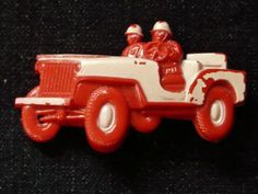 a red and white toy truck with santa clause riding in the back, on a black background