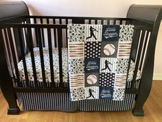 a baby crib with a baseball quilt on it