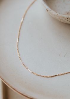 Delicate textured bars are linked together with delicate chain to add a little whimsical sparkle. Offered in 16" or 18" lengths. Available in 14kt Gold Fill + Sterling Silver. KJ styles her Mari Chain with our Lenny Chain and Tiny Freshwater Pearl Necklace. Love this chain? Check out our Mari Choker and Mari Bracelet. Handmade in Eau Claire, WI. Our jewelry is handmade so each piece will be unique and may vary slightly from what is pictured. Rose Gold Necklace With Delicate Chain And Rectangular Links, Minimalist 14k Gold Delicate Chain Necklace, 14k Yellow Gold Bar Necklace With Delicate Chain, Dainty 14k Gold Necklace With Rectangular Links, Dainty 14k Gold Filled Necklace With Rectangular Links, Dainty Bar Necklace With Satellite Chain, 14k Gold Bar Necklace With Delicate Chain, Dainty Bar Necklace With Cable Chain, Dainty Bar Necklace With Cable Chain As A Gift