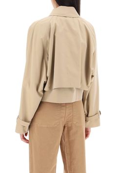 This Burberry cropped jacket is cut from lightweight cotton gabardine and boasts a double layer design, composed of a sleeveless base and a non-removable long-sleeved overlay. It closes with a double-slider zip beneath a snap placket and features a shirt collar with throat latch, side welt pockets and two inside pockets. The dolman sleeves bear a raglan cut on the back and belted cuffs. Burberry Check cotton lining. The model is 177 cm tall and wears a size UK 6. Size Info UK Color Detail Beige Cropped Beige Cotton Outerwear, Chic Oversized Cropped Outerwear, Oversized Cropped Jacket For Workwear, Chic Beige Cotton Cropped Jacket, Cropped Cotton Workwear Jacket, Cropped Cotton Jacket For Workwear, Layer Design, Cropped Jacket, Burberry Bag