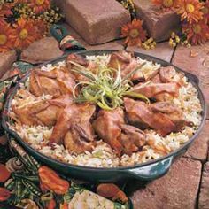 chicken and rice dish with orange flowers in the backgroung, surrounded by bricks