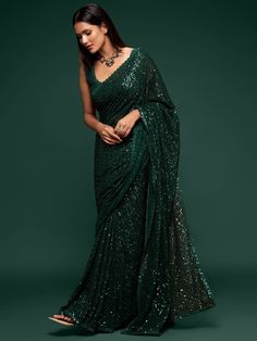 This Emerald Green sequinned georgette saree comes with an unstitched blouse. Wear it to garden parties or weddings, you are guaranteed to make heads turn. This classic piece makes needs no further styling making it a versatile piece for any and every event. Standard and Customized blouse stitching available for an additional fee. Please note this blouse can be stitched up to a size 44, and cannot be made with sleeves. For the customized option, our team will reach out to you after the order is Evening Saree Party Wear, Green Sari, Sequins Saree, Evening Reception, Sequence Saree, Sequin Saree, Party Sarees, Color Blouse, Party Wear Saree