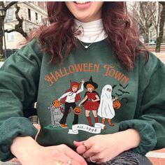 It's beginning to feel like spooky season, and this vintage 90s inspired Halloween Town sweatshirt is adorable and just the crewneck you need for fall! This vintage style sweatshirt is a great retro option to add to any basic outfit, and also brings on the nostalgia! FAST PRODUCTION AND TURN AROUND TIME WITH A STAR SELLER RATED STORE 💖⭐ SIZING Relaxed fit - size up for a more baggy fit! RETURN POLICY Please check our shop policies FAQ for more info!  About SUGAR FACE GOODS   💖 Woman designed, owned & operated  ⛅ Lightweight packaging  🌟 5-star rated store  📦 1-2 day production time & fast shipping  🫶 Every review given to our store is returned in love with a special discount   💌 Got an idea we don't make yet? Please send me a message Retro Halloween Cats Crewneck, Vintage Halloween S Vintage Halloween Sweatshirt For Streetwear, Vintage Halloween Long Sleeve Sweatshirt, Vintage Long Sleeve Halloween Sweatshirt, 90s Graphic Print Fall Sweatshirt, 90s Crew Neck Halloween Tops, Vintage Crew Neck Halloween Tops, Vintage Crew Neck Tops For Halloween, Vintage Tops For Costume Party In Fall, Fall Crew Neck T-shirt For Costume Party