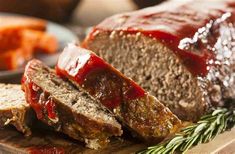 sliced meatloaf with ketchup on a cutting board