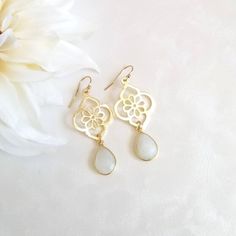 Make an elegant statement in these gorgeous Moonstone teardrop earrings.Earrings consist of a modern design brushed gold flower that is accented with a natural bezel set faceted Moonstone.Details:* Brushed Gold Flower Measures about 28 mm* Each flower is 14 k gold plated on brass,. Lead, nickel and cadminum free with a non tarnishing coat* Natural teardrop bezel set faceted Moonstone measuring about 14 mm* 14 k Gold Filled Ear Wires (not plated)* Earrings measure about 2 inchesAll jewelry includ Bride Earrings Gold, October Jewelry, Evening Earrings, Bride Earrings, Moonstone Earrings, Facepaint, Gold Flower, Gold Flowers, Leaf Earrings