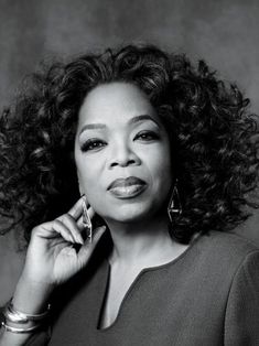 a black and white photo of a woman with curly hair