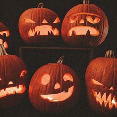 several carved pumpkins with faces on them