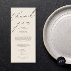 a white plate with a thank you card on it next to a black and white background