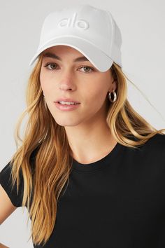 Top off your look with Alo's limited edition, fresh take on the classic dad cap. This street style must-have features our signature logo and the adjustable velcro strap back makes this piece fit for everybody. White Cap Outfit, Yoga Marketing, Cap Outfit, Sweat Set, Woman Back, Dad Cap, White Caps, Dad Caps, Back Women