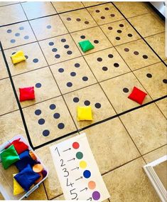 a board game with pieces of colored paper on the floor