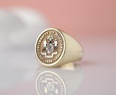 Introducing our stunning 14k Solid Gold custom college class signet ring! This exquisite piece is the perfect way to commemorate your academic achievement in style. Crafted with top-quality materials, this unique ring can be tailored to feature your graduation year or college insignia for a personalized touch. Whether as a gift for yourself or a loved one, this ring is sure to be cherished for years to come. Make a statement with this timeless keepsake that celebrates your academic journey in a Graduation Rings College, Class Rings College, College Class, Graduation Rings, Graduation Year, College Classes, Academic Achievement, Jewelry Workshop, Gold Signet Ring