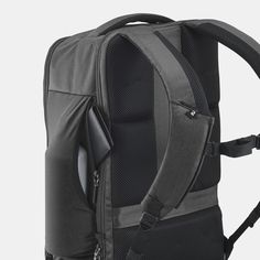 the back view of a backpack with an external compartment and zippered pocket on the side