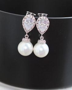 these pearl earring made using round white pearl and zirconia sterling silver post . earring are 1 '' long from the top . pearl are 10mm link for matching bracelet . https://www.etsy.com/listing/206631374/pearl-bridal-bracelet-bridal-jewelry https://www.etsy.com/shop/arbjewelry White Pearl Drop Earrings In Cubic Zirconia, Pearl-embellished Cubic Zirconia Drop Earrings, Pearl White Bridal Earrings With Pearl Drop, White Bridal Earrings With Pearl Charm And Cubic Zirconia, Pearl White Pearl Drop Earrings In Cubic Zirconia, Pearl White Pearl Drop Earrings With Cubic Zirconia, Elegant Pearl Embellished Cubic Zirconia Earrings, Diamond White Cubic Zirconia Pearl Earrings For Wedding, Pear-shaped Pearl White Jewelry With Cubic Zirconia