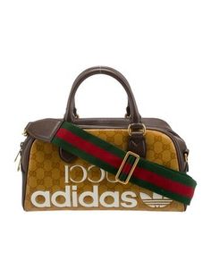 Gucci x Adidas Shoulder BagNeutralsGG Supreme & Web AccentGold-Tone HardwareRolled Handles & Single Shoulder StrapCanvas Lining & Single Interior PocketZip Closure at TopProtective Feet at Base Gucci Duffel Bag Travel, Gucci X Adidas, Adidas Bag, Mini Duffle Bag, Adidas Bags, Handbag Handles, Duffle Bag, Women Handbags, Handles