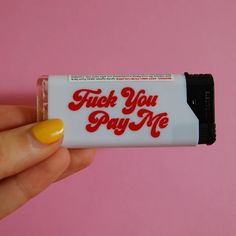 a hand holding a small white tube with red writing on it that says, fuel you pay me