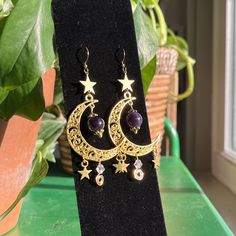 Mystical Gold Moon Phase Earrings, Celestial Moon Earrings With Star Charm, Celestial Moon Shaped Earrings With Star Charm, Celestial Moon-shaped Earrings With Star Charm, Celestial Metal Jewelry With Dangling Charms, Celestial Gold Jewelry For Festivals, Gold Star Charm Jewelry For Festival, Gold Moon-shaped Festival Jewelry, Gold Dangle Earrings With Moon Phase Detail