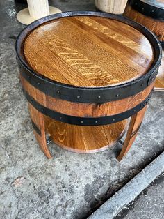 a wooden barrel sitting on top of a cement floor