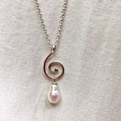 "A gorgeous sterling silver pearl drop necklace, with a textured silver spiral. * 9.5 x 6mm teardrop freshwater pearl  * handmade sterling silver spiral * 18\" / 45cm sterling silver chain * 1\" / 2.5cm pendant length  This one of a kind pearl pendant features a textured silver spiral and a beautiful, lustrous freshwater pearl. Perfect as a stacking necklace, a gift for mum, for bridal jewellery, beach weddings, a 30th wedding anniversary gift for her, or a lovely treat for yourself. I hand make Elegant Sterling Silver Swirl Necklace, Sterling Silver Teardrop Pearl Necklace, Unique Pearl Jewelry, Black Pearl Bracelet, How To Clean Earrings, Spiral Necklace, Pearl Drop Necklace, Pendant Necklace Silver, Stacked Necklaces