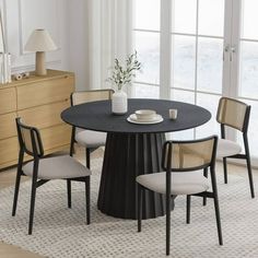 a dining table with four chairs around it