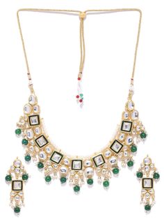 This impressive jewelry set consists of a kundan studded necklace and a pair of matching drop earrings. The beautiful necklace shown in green comes gold-plated with kundan stone studs and green & white accent beads, and secured with an adjustable drawstring closure. A pair of matching drop earrings come secured with a post and back closure. This statement piece can add impact to any outfit for any festive occasion! Product color may vary based on the monitor or screen you are using.See FAQ for m Green Jeweled Kundan Necklace For Festivals, Green Jeweled Kundan Necklace For Celebration, Green Kundan Jewelry Sets As Gift, Green Kundan Necklace For Festive Gift, Celebration Green Jeweled Kundan Necklace, Green Jeweled Bridal Necklace For Festive Occasions, Festive Green Jeweled Jewelry Sets, Festive Jeweled Green Bridal Necklace, Green Jeweled Bridal Necklace For Festivals