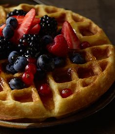 a waffle topped with berries and blueberries