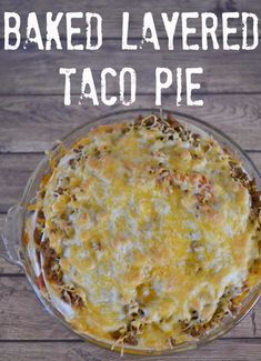 baked layered taco pie in a glass dish with text overlay that reads baked layered taco pie