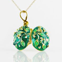 "Jewelry locket pendant with the frog surprise inside. Enameled and 24 K gold plated over solid sterling silver, this pendant is designed and made in our NJ shop in the tradition of Faberge jewelry. A green frog , in a color, matching the outside surface of the pendant, sits on white leaves, and is fixed steadily inside the locket. The egg is 20 mm (0.7\") long without a bail for a chain. It comes with 18' sterling silver gold plated chain and in a gift box. If you feel that you need a longer ch Oval Enamel Locket Necklace, Oval Locket Necklace In Enamel, Enamel Round Pendant Locket Jewelry, Green Pendant Necklace For Keepsake, Green Pendant Necklace As Keepsake, Enamel Locket Pendant Necklace, Enamel Round Pendant Necklace For Anniversary, Anniversary Enamel Round Pendant Necklace, Art Nouveau Locket