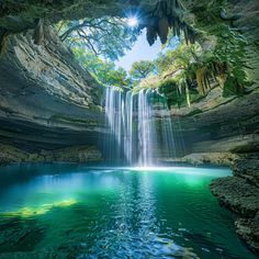 there is a large waterfall in the middle of this cave with water running down it