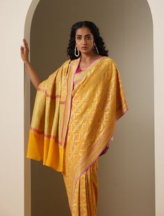 "Elevate Your Ethnic Look with Khinkhwab's Exquisite Banarasi Georgette Saree - Add a Dash of Your Favorite Color!" Product Description: Introducing an exquisite masterpiece from Khinkhwab, the exclusive Banarasi Georgette Saree that lets you add a touch of your favorite color to your ethnic ensemble. Crafted with pure Georgette silk, this saree features a captivating Phekua Jaal weave in Gold Zari with delicate woven Bandhani, radiating elegance and individuality. Category: Georgette Saree Fabr Yellow Brocade Traditional Wear With Cutdana, Yellow Cutdana Brocade Traditional Wear, Brocade Saree For Ceremonial Use During Diwali, Yellow Brocade Traditional Wear For Festive Occasions, Transitional Banarasi Silk Pre-draped Saree, Tussar Silk Traditional Wear For Eid Ceremonies, Tussar Silk Traditional Wear For Ceremonial Occasions And Eid, Ceremonial Tussar Silk Traditional Wear For Eid, Eid Ceremonial Tussar Silk Traditional Wear