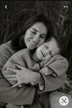 a woman holding a baby in her arms and smiling at the camera with an instagram button