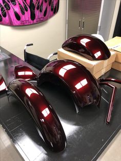 two shiny red mirrors on top of a table