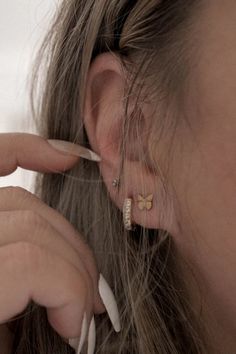 Girl wearing mini hoop earrings and butterfly studs Everyday Gold Butterfly-shaped Jewelry, Gold Huggie Earrings With Butterfly Charm, Gold Minimalist Earrings With Butterfly Charm, Minimalist Gold Earrings With Butterfly Charm, Gold Earrings With Butterfly Charm For Everyday, Earrings Stack, Stacking Earrings, Small Stud Earrings, Earrings Butterfly