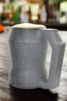 a gray mug sitting on top of a wooden table