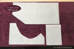 a piece of paper is cut out to make a quilted wall hanging or table runner