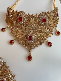 Traditional Gold Choker with detailed work and beautiful stones to upgrade any outfit! Perfect for Bridal wear! It comes as a full set in 2 colors to go for any outfit! Eid Lehenga With Stone Work, Anarkali Lehenga With Intricate Design For Eid, Designer Lehenga With Stone Work For Eid, Elegant Traditional Wear With Stone Work For Festivals, Elegant Traditional Wear With Stone Work For Designer Occasions, Elegant Festive Choli With Stone Work, Elegant Hand Set Traditional Wear For Diwali, Elegant Stone Work Lehenga For Eid, Bollywood Kundan Sets For Designer Wear