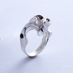 A simple band blooms into an intricate convolution of sterling silver. This ring is 3D printed in wax, then cast in silver using lost wax casting. Also available in brass, 14k gold, 18k gold, palladium, and platinum by special order. Our Florescence collection is inspired by the biomechanics of growing leaves and blooming flowers. Each piece emerges from a computational simulation of differential growth, a surface that grows at different rates in different location. The flowering structures expa Hand Forged Sterling Silver Rings For Formal Occasions, Unique Hand Cast Sterling Silver Signet Ring, Formal Hand Forged Sterling Silver Rings, Formal Hand Cast Sterling Silver Rings, Modernist Sterling Silver Wedding Rings, Modernist Hand Cast Sterling Silver Rings, Unique Sculpted Silver Jewelry, Unique Hand Cast Signet Ring For Anniversary, Modernist Hand-cast Jewelry Ring