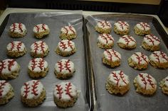 two trays filled with cookies covered in white frosting