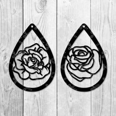 two tear shaped metal wall hangings with roses on them