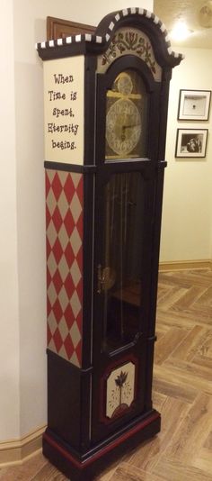 an antique grandfather clock on display in a room with wood flooring and white walls