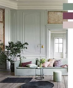 a living room filled with furniture and a potted plant