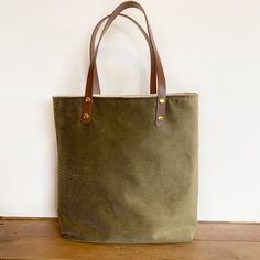 "Small, simple tote with just enough room to fit a notebook, piano books or laptop.  Specs: Approx 15\"x14\" Faux leather straps Small gusset bottom 2 interior slip pockets Add a matching coin purse, boxy bag or coordinating pouch for more interior storage ideas! Or for gifting!" Rectangular Khaki Canvas Bag For Everyday, Khaki Cotton Bags With Leather Handles, Eco-friendly Waxed Canvas Tote Bag, Green Canvas Tote Bag For Everyday, Khaki Canvas Tote Bag With Canvas Lining, Green Everyday Tote Canvas Bag, Green Everyday Canvas Tote Bag, Khaki Canvas Tote Bag, Green Everyday Bags With Canvas Lining