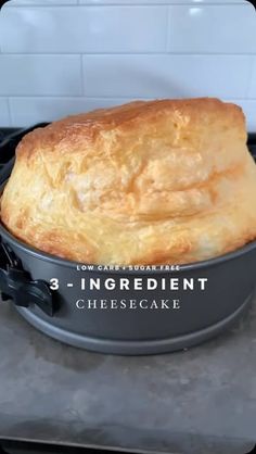 a baked bread in a pan on top of a stove with the words, 3 ingredient cheesecake