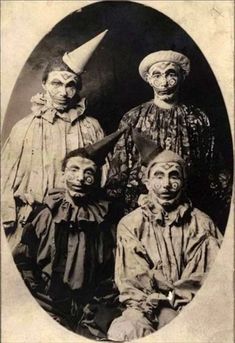 an old black and white photo of three men with clown faces on their heads, one wearing a party hat