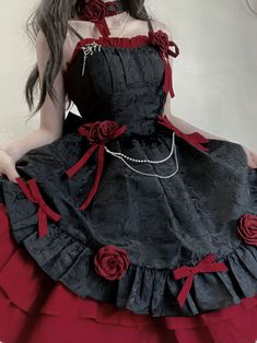 a woman wearing a black and red dress with roses on it