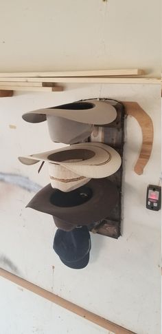 several hats are hanging on the wall