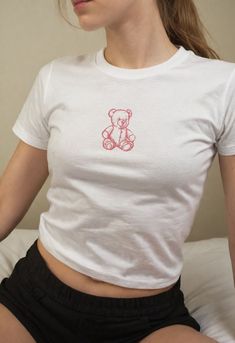 🍓🥤Introducing our Retro teddy bear Baby Tees, a delightful nod to the beloved 90s and Y2K fashion trends. "Girlhood Y2K Baby Tee" -- a must-have for fashion-forward enthusiasts embracing the latest trends. This Y2K baby tee combines indie kid style with the VSCO girl aesthetic.  You will sure turn heads and make a bold statement with our "retro teddy Y2K Baby Tee". With its unique blend of indie kid vibes and Y2K fashion.  Enjoy the heavy cotton with a vintage feel on this baby tee.   Please c Cheap Bear Print Graphic Tee, Teddy Bear Tshirts, Casual Bear Design Crew Neck Top, Cute Cotton T-shirt With Bear Design, Cute Bear Print Crew Neck T-shirt, Cute Short Sleeve T-shirt With Bear Print, Short Sleeve Graphic Tee With Bear Design, Casual Short Sleeve Tops With Bear Design, White Cotton Tops With Bear Print